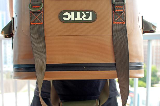 Close up of brown RTIC backpack cooler held upside-down