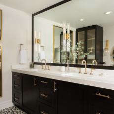 Black and White Primary Bathroom With Brass Sconces