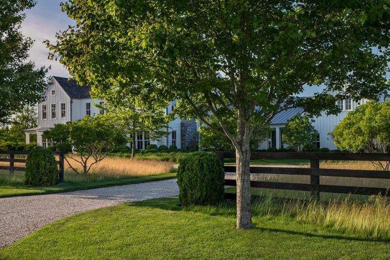 Black Wooden Fence Surrounding Beautiful White Farmhouse