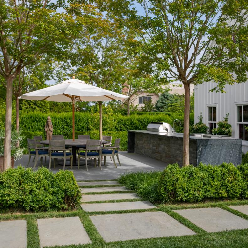 Outdoor Kitchen and Dining Area With Concrete Pavers