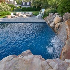 Natural Stone Waterfall Crowns Pool in Backyard Remodel