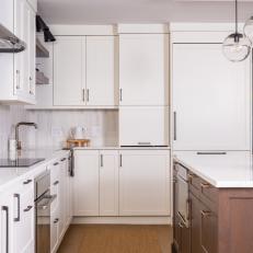 White Open Plan Kitchen With Leaf Arrangement