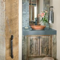 Rustic Powder Room With Carved Stool