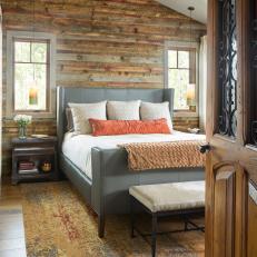 Rustic Main Bedroom With Orange Pillow