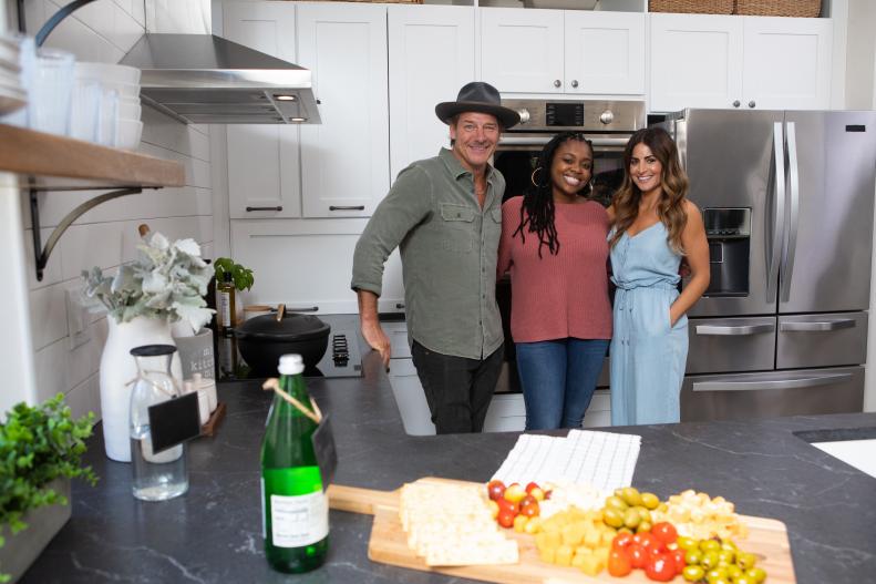 As seen on HGTV's Ty Breaker, host Ty Pennington (L) and co-host Alison Victoria (R) with homeowner Morgan Barham (C) in her newly renovated kitchen.