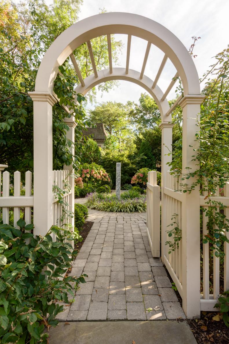 Garden Viewed Through Pergola and Open Gate