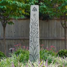 Obelisk In Garden Surrounded by Flowers