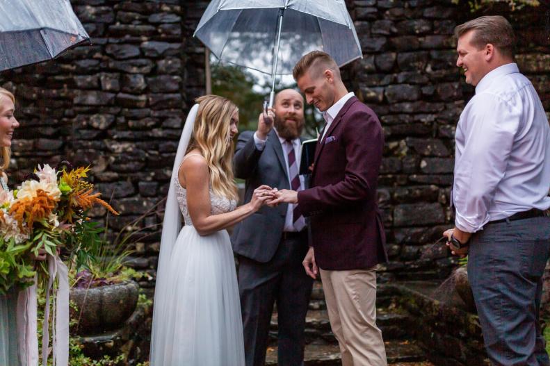 Clear Umbrella Above Man and Woman in Outdoor Wedding Ceremony