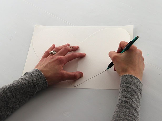 On another piece of card stock, use the first heart as a template to trace an identical one and cut it out.