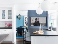This chef's kitchen includes white fixtures and a blue cabinet.