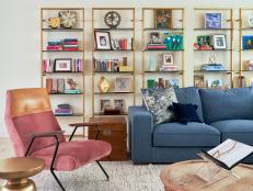 “These parents wanted a family room that celebrated theirs,” says designer Elizabeth Krueger. Brass and glass bookshelves in the Lincolnshire, IL, home deliver style and substance: There are family photos (which stand out on a stack of books), pieces from overseas trips to visit relatives, and a sprinkling of sculptures. “I knew we nailed it the minute their 3-year-old saw his art on the shelf and his face lit up,” says Krueger.