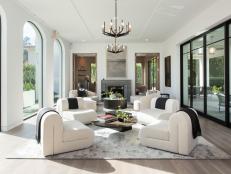 Long white room with arched windows and black metal accents.