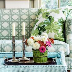 Blue Wicker Coffee Table With Candlesticks and Flower Arrangement 
