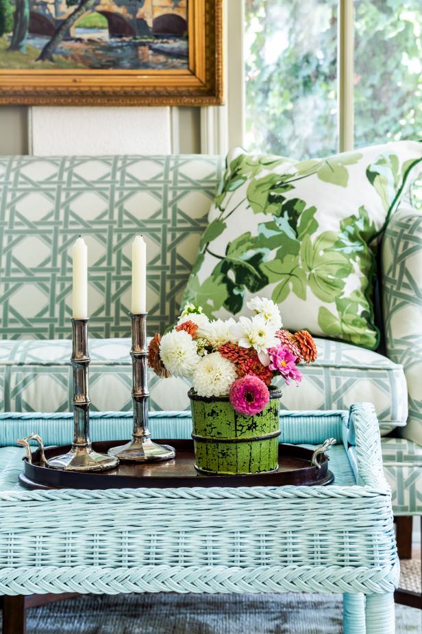 Silver bamboo candlesticks and bright dahlias on black tray.