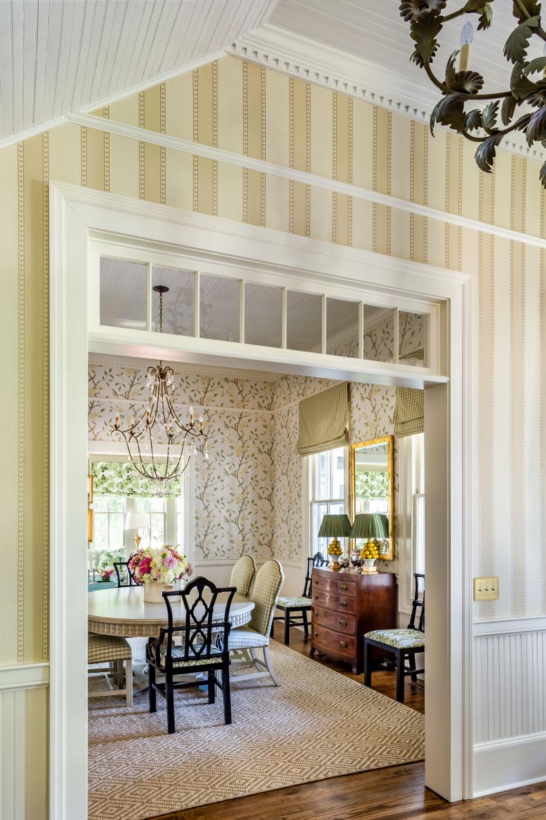 Striped wallpaper and cased opening to dining room. 