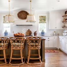 Traditional Kitchen Island With Bent Wood Stools and Pendants 