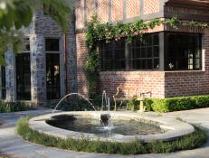 Gorgeous Fountain and Rose-Lined Brick Wall