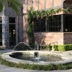 Gorgeous Fountain and Rose-Lined Brick Wall