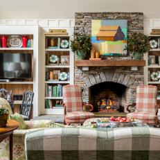 Traditional Pastel Living Room With Built in Shelves, Stone Fireplace and Buffalo Plaid Upholstery