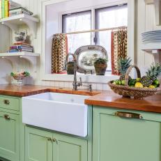Traditional Green and White Kitchen With Farmhouse Sink and Printed Curtains 
