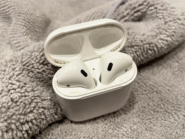 Cleaning a dirty pair of Apple AirPods.