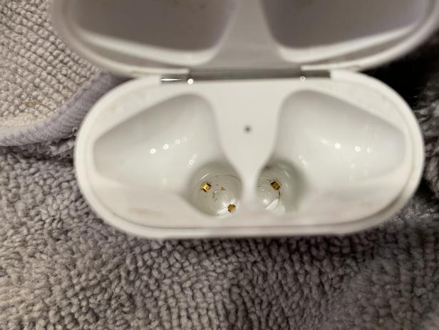 Cleaning a dirty pair of Apple AirPods.
