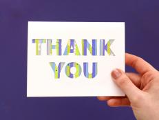 Woman Holding a Card with a Purple and Green Thank You Card 