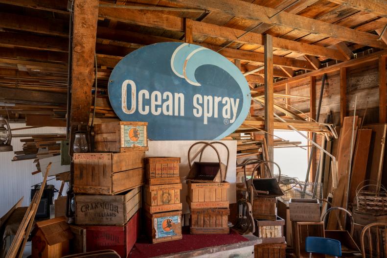 Vintage Ocean Spray Sign Hangs in Barn Surround By Old Wooden Crates