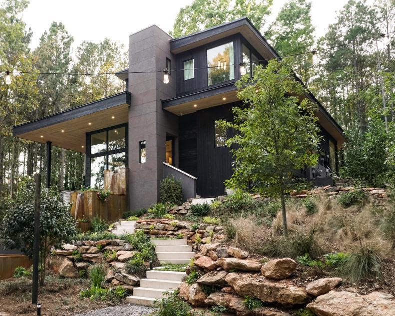 Mixed materials and a color palette for the exterior that "blends into the landscape" was essential says architect Steve Dray. "One of my favorite features inside is the open staircase that connects all floor levels very well" says Dray.