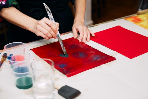 Once the colors are diluted, take a clean foam brush and paint water quickly across the paper horizontally. Tip: You don’t want the paper to peel up. Then, take a paint brush and dip it into the diluted paint to add color to the wet paper. Put opposite colors on opposite color papers, like yellow paper gets red and green paint and red paper will get green and blue.