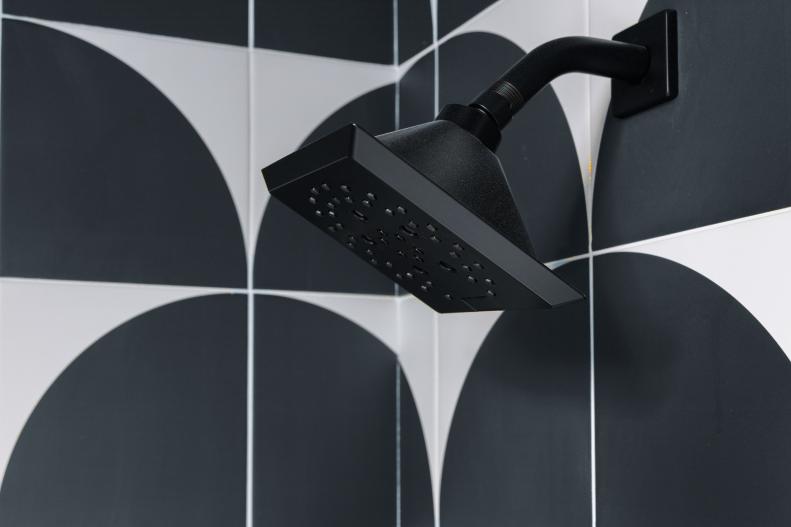 A matte black shower head provides state of the art technology in a modern style that plays off the modern, Scandinavian inspired space.