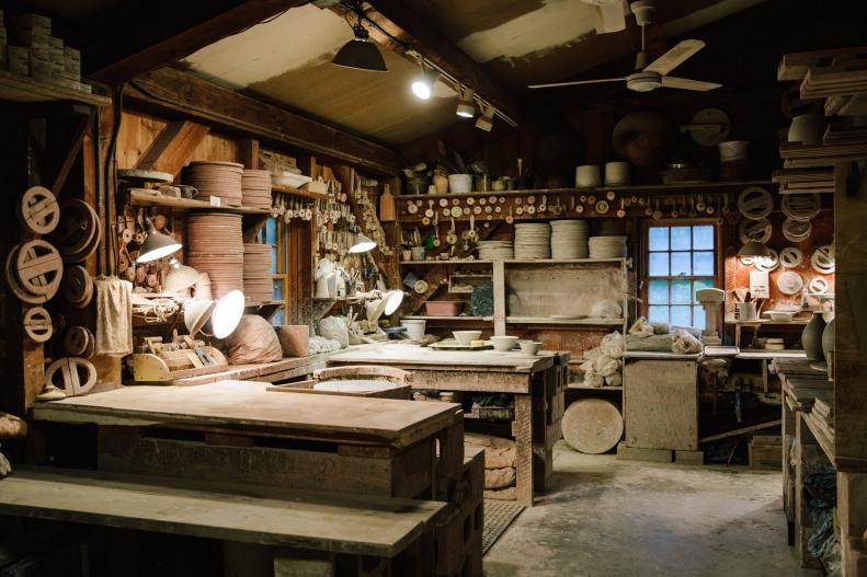 Pottery Shop With Pots on Shelves, Work Tables, Wheels, Wall of Tools