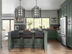 The kitchen island includes a pro-style range with cabinets and drawers on one side, and seating on the other. This well-placed island adds extra counter space, and helps with traffic flow in, out, and around the kitchen.