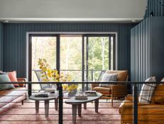 This loft includes an indoor seating area and large glass doors that lead to an enticing deck outside, for enjoying all the beauty of this luxury cabin’s spectacular Warren, Vermont location. 