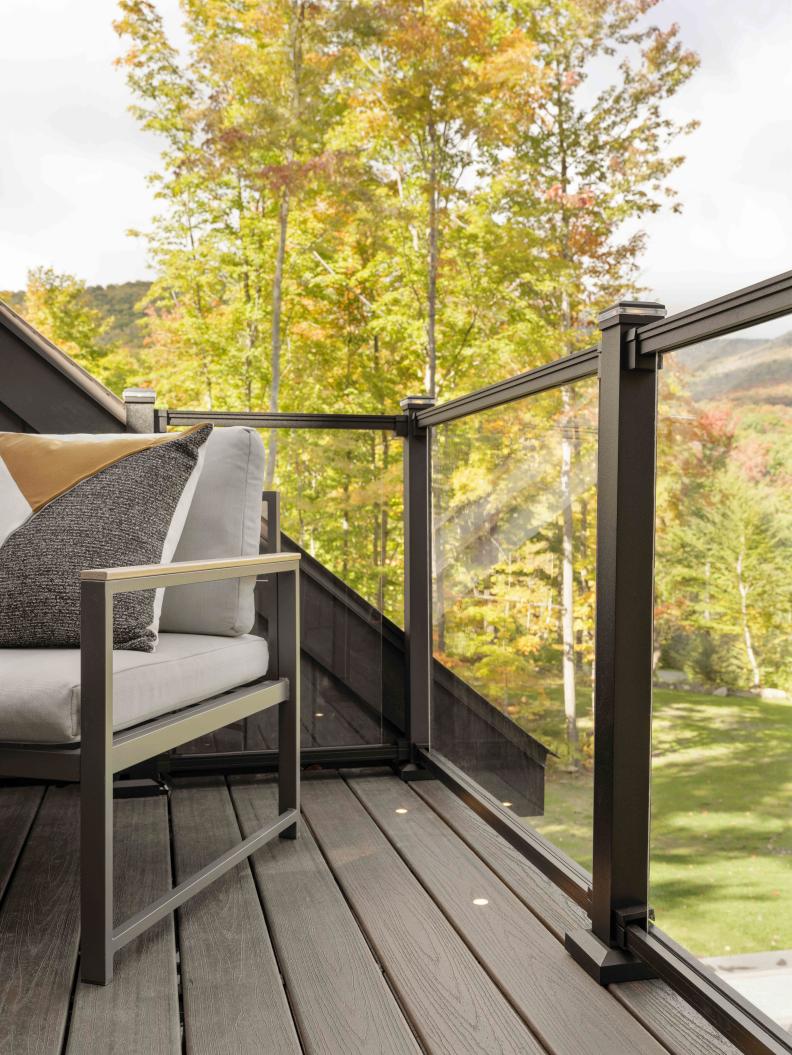 The modern railing system on the deck with glass panels provides safety, but doesn’t block the beautiful views from this second floor of the home. Integrated lights in the decking helps illuminate the space during the evening hours.