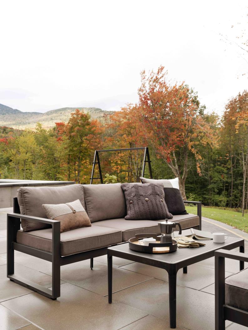 The seating area on the upper patio space provides a lush location for a morning coffee break while enjoying the mountain view.