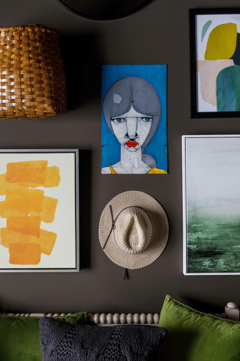 A mix of folk and modern paintings are hung gallery style above the daybed with locally sourced antiques from Vermont shops adding local textures and artistic color to the dramatic space.
