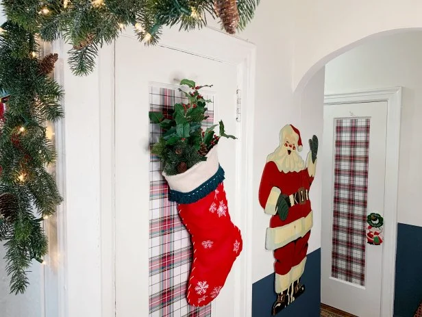 Use tissue paper, batting or scrap paper to fill the stocking. Rip the paper into small pieces, crumple them up and then carefully place them inside the stocking. Add faux greenery popping out of the stocking for a true festive feel. Hang on a front door or inside your home to spread some cheer!