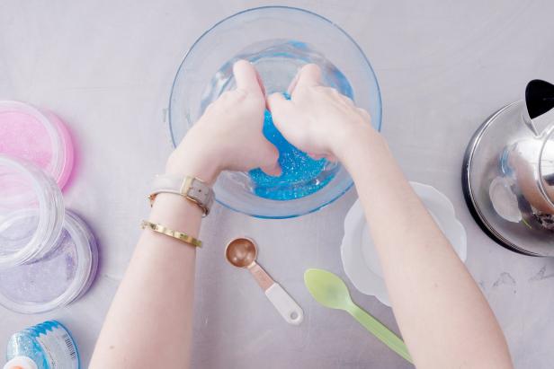 Use your hands to gently pull the glue from the bowl and knead it until it doesn’t feel sticky. Keep dipping it into the borax mixture and kneading until all of the sticky spots are gone.