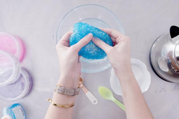 Use your hands to gently pull the glue from the bowl and knead it until it doesn’t feel sticky. Keep dipping it into the borax mixture and kneading until all of the sticky spots are gone.