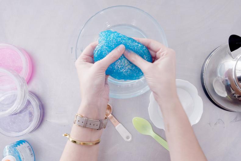 Woman kneading blue slime