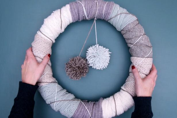 Tie on yarn pom poms to hang down into the center of the wreath.
