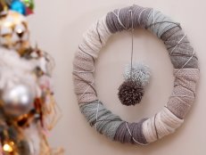 Blue, gray, and white fabric wreath hung on a wall