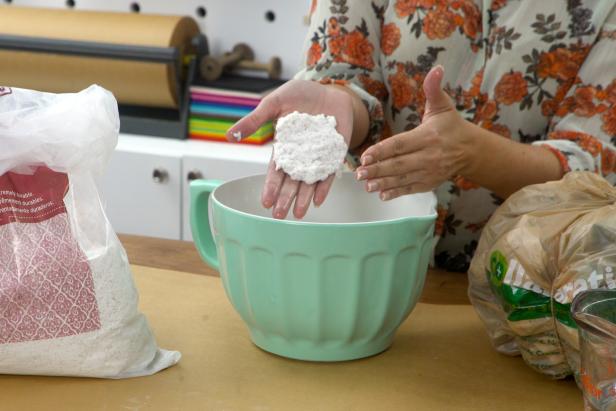 Scoop some paper mache pulp into a bowl and add water. Mix together until the paper mache sticks to itself and you can form shapes.