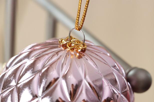Gold chain wrapped around the ornament hanger 