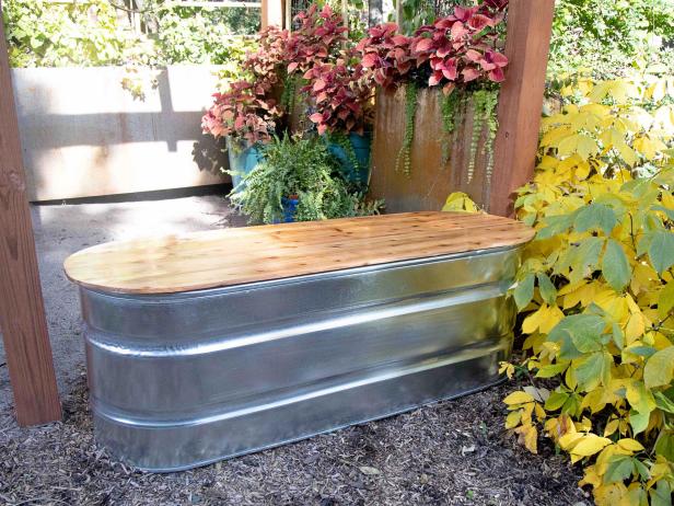 Upcycled Galvanized Stock Tank Used as Garden Tool Storage