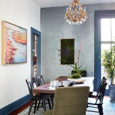 Eclectic Dining Room With Accent Wall and Chandelier 