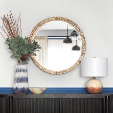 Gold-Rimmed Mirror Over Contemporary Sideboard