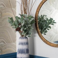 Blue Vase With Greenery and Gold-Rimmed Mirror
