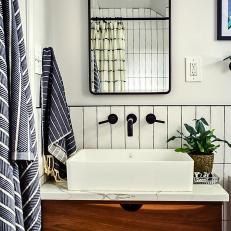Black and White Bathroom With Dark Wood Drawers